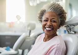 Older woman smiling after dental implant placement
