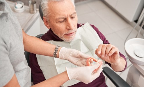 Man getting dentures at dentist