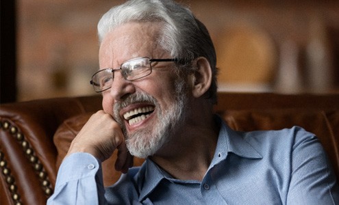 Man laughing on couch