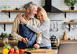 Senior couple being affectionate while preparing a meal