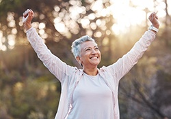 Healthy older woman standing outdoors?