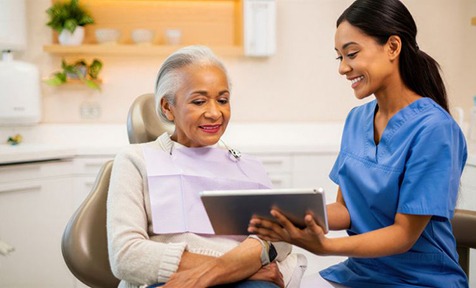 Senior patient talking with dental team member