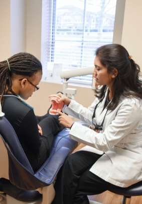 Dentist showing dental patient a smile model in Fort Mill