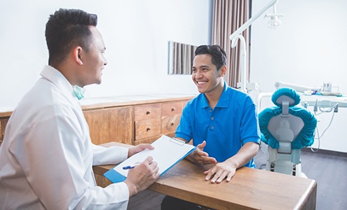 patient talking to dentist about dental insurance 