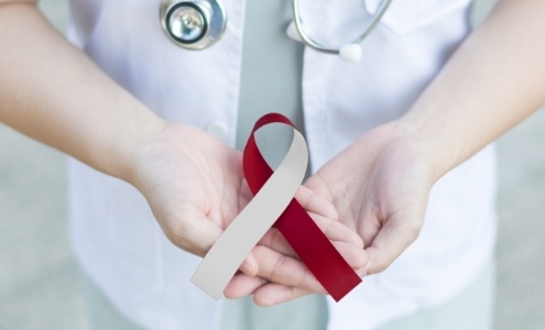 Dentist holding an oral cancer awareness ribbon