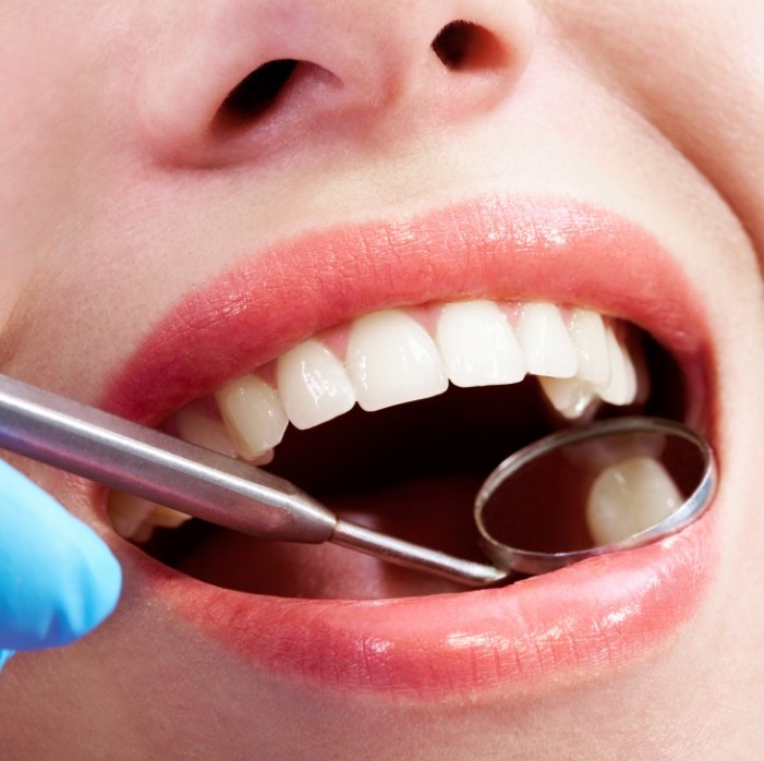 Dentist examining smile after restorative dentistry