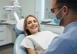 Smiling dental patient reclined in treatment chair