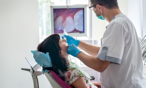 Dentist using intraoral cameara to capture smile images