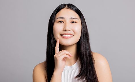 a woman smiling after getting veneers in Fort Mill