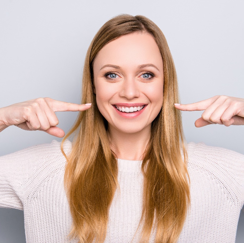 young woman smiling after getting teeth whitening in Fort Mill