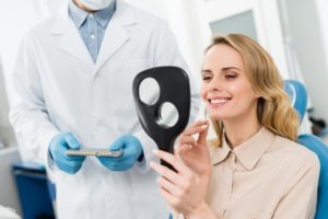 a woman admiring her smile makeover