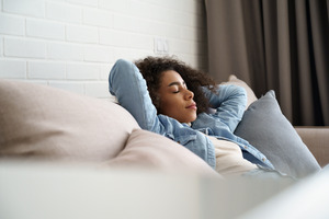 Woman at home resting on her couch