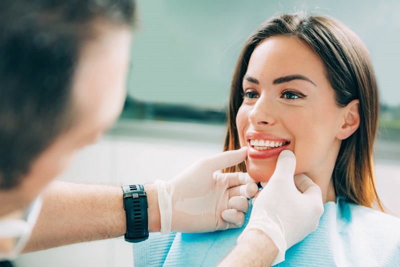 A cosmetic dentist consulting with a patient