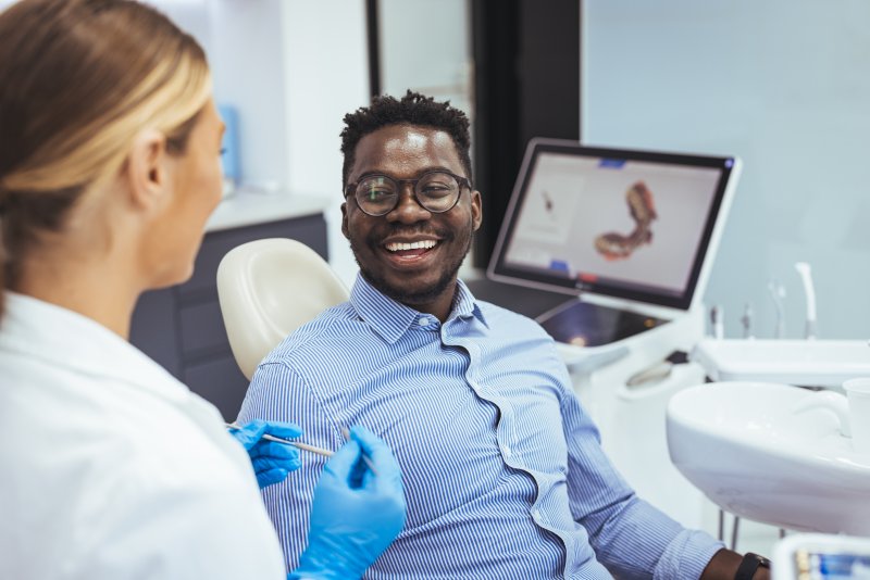 Patient smiling at their dental implant surgery consultation