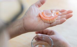 Person holding their dentures