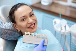 a woman smiling in preparation for cosmetic dentistry