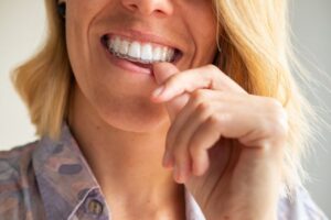 Woman putting in her Invisalign